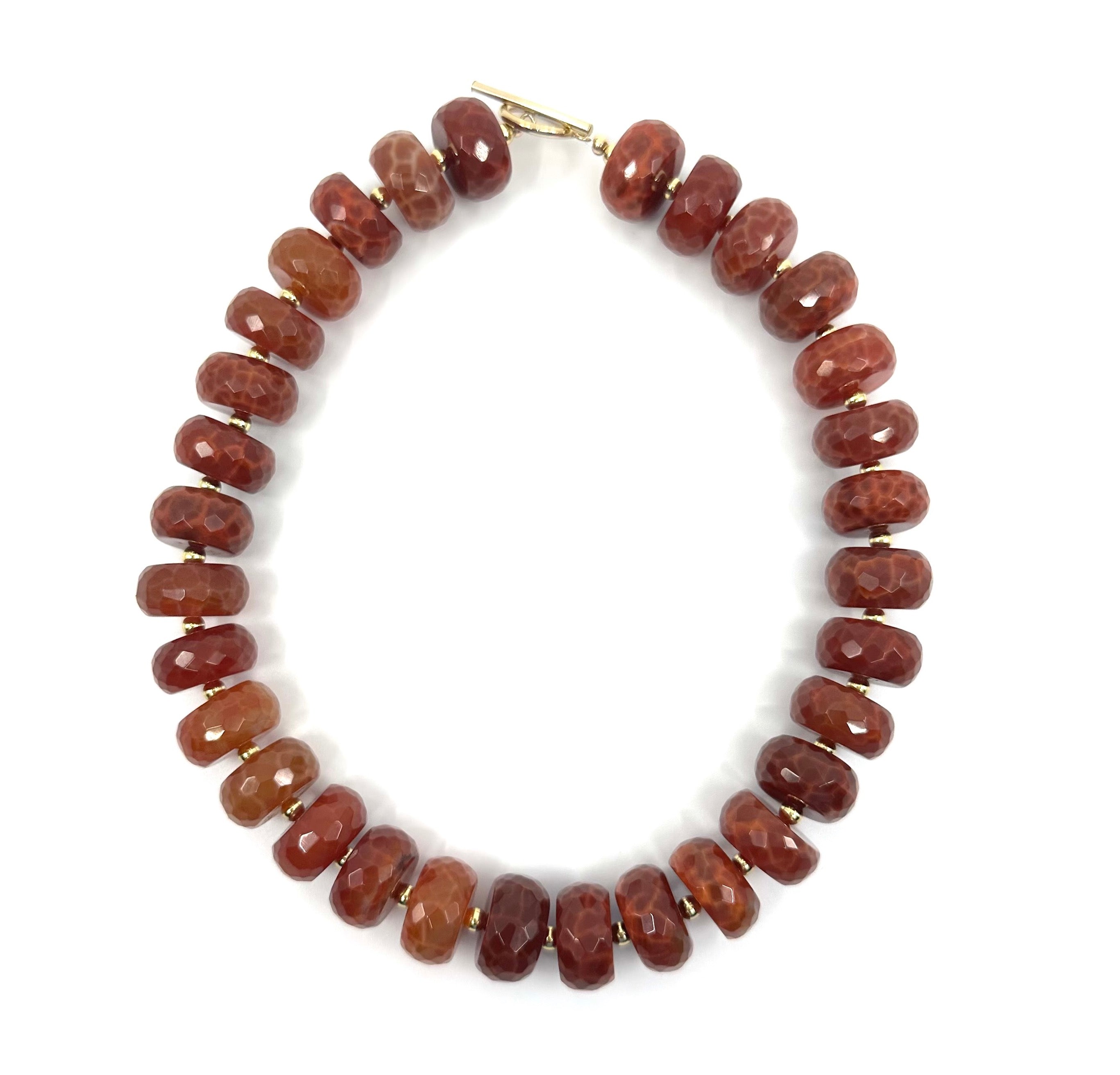 Elegant fire agate choker by rraine featuring faceted fire agate beads and a gold-filled clasp, measuring 16 inches in length.