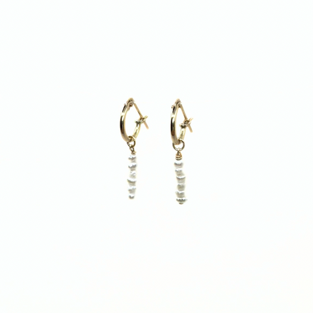 Mini pearl hoop earrings by rraine featuring gold-filled 10mm hoops adorned with mini pearls, sold as a pair.